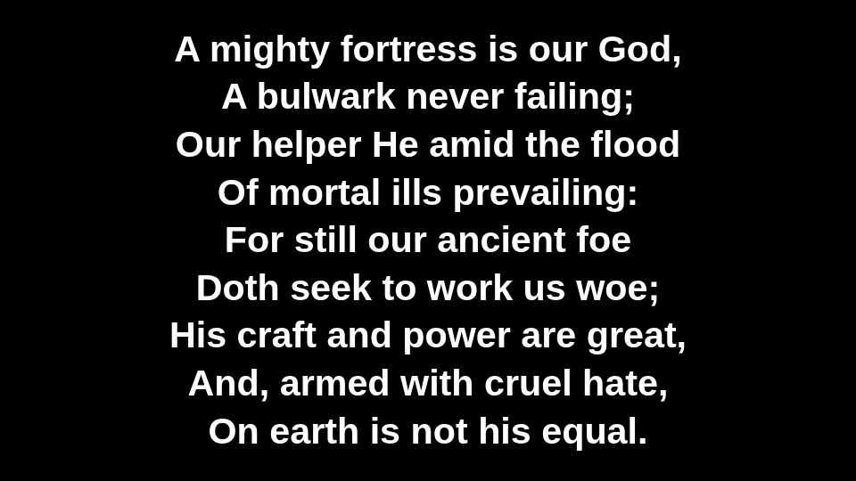 Hymn lyrics on the big screen, large white text on a black background